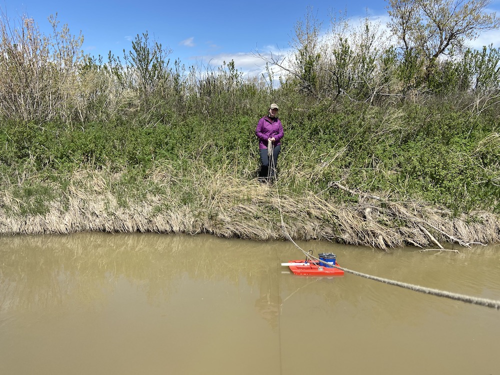 Allie measures flow rates on Rosebud Creek