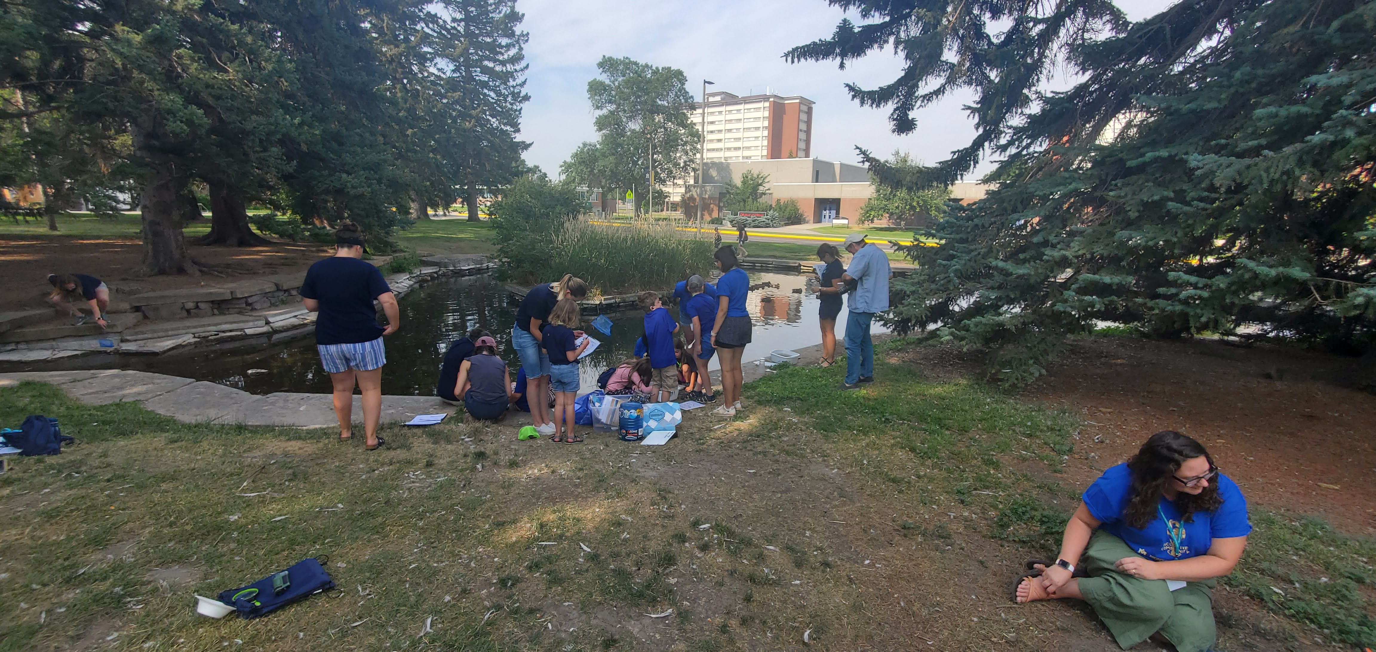 ICC campers and guides sit around the MSU Duck Pond
