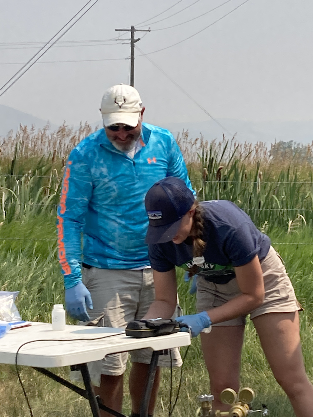 Cory Beatty and Makenzy Gilsdorf check sampling equipment