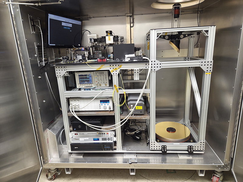 large metal cabinet on wheels containing lidar instrument with many components and a monitor