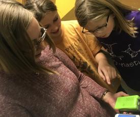 Students looking at Pocket Lab air sensor