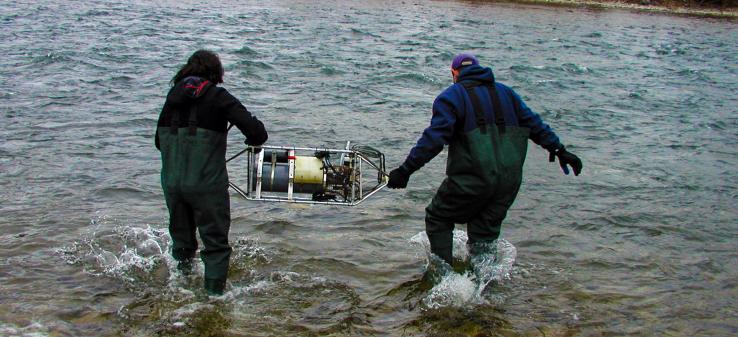 Researchers Cory Beatty and Laura Jungst deploy a SAMI sensor in the Clark Fork River near Missoula. Photo by Mike DeGrandpre