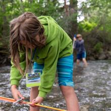 Peaks & Potentials camper studying stream flow. Photo by Brendan Kristiansen.