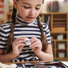 Girl holding matchbox car