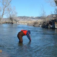 A volunteer takes a water sample on the Crow Indian Reservation. MSU photo.