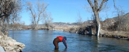 A volunteer takes a water sample on the Crow Indian Reservation. MSU photo.
